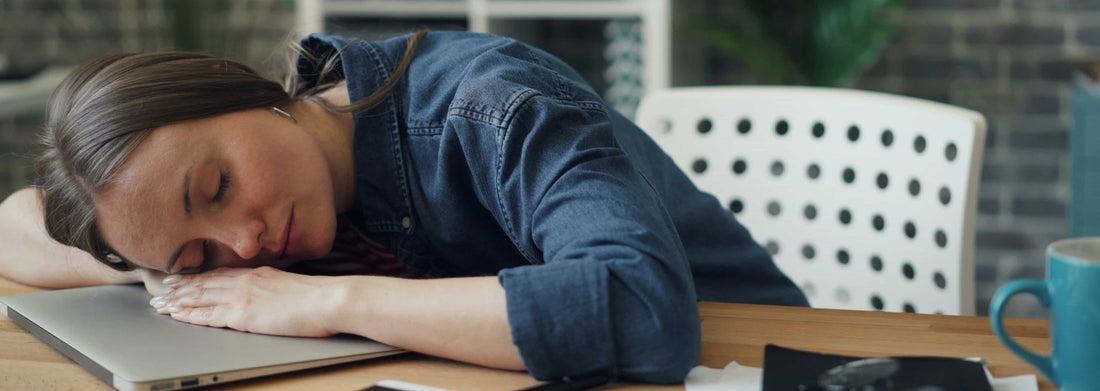 woman sleeping on a desk after taking the Best Sleep Aid for Adults with Anxiety