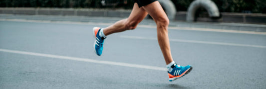 Legs of a person running on the street