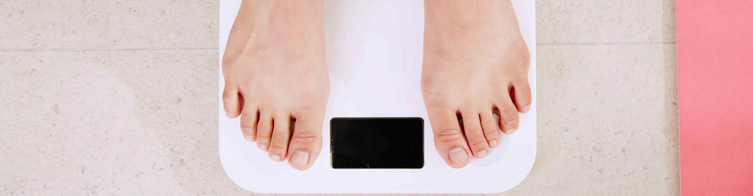 feet on a weight scale from a person wondering about what is the best method for weight control?