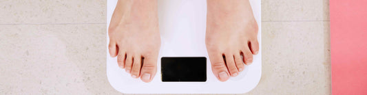 feet on a weight scale from a person wondering about what is the best method for weight control?