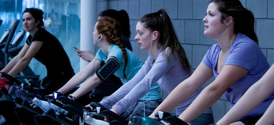 4 women at a gym riding electric bikes