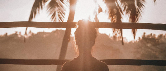 Woman staring at a sunset
