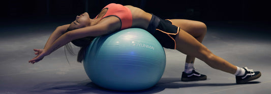 Woman working out with a ball after taking dietary supplements