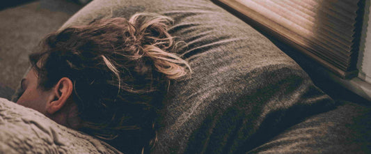 Woman sleeping wondering about What Is The Natural Pill That Makes You Sleep?