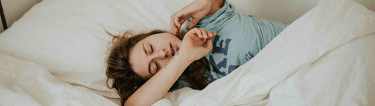 Woman in bed pondering about the Best Vitamins for Sleep and Anxiety