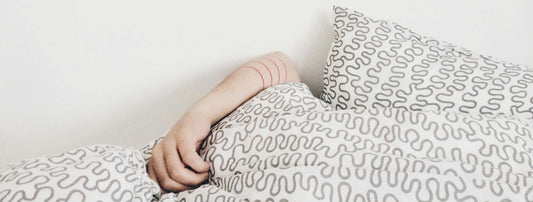 person sleeping in a bed after taking the Strongest Sleep Aid Over the Counter