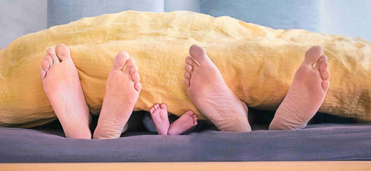 A family of three sleeping on a bed after taking one of the top ten sleeping pills