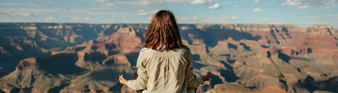 Woman meditating in a mountain range