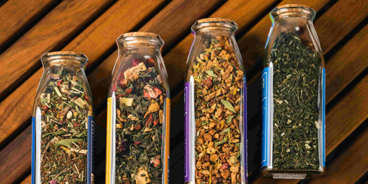 4 glass jars containing minerals, herbs, vitamins, and supplements