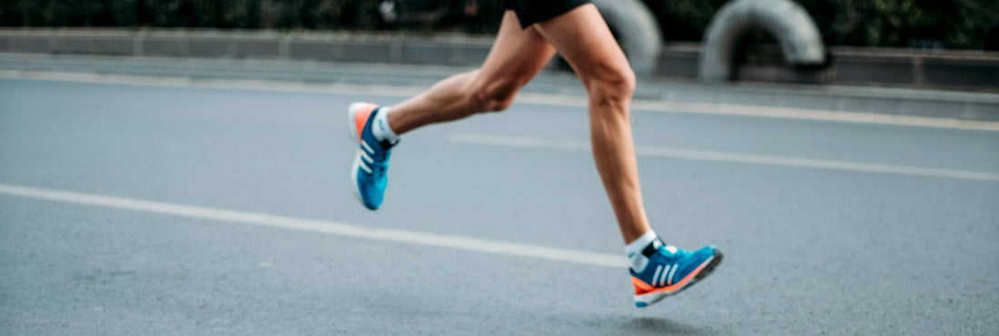 Legs of a person running on the street